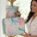 Hanging Toiletry Bag from Mindful Marlo in Haven design, hanging with hook on hat stand, partly closed
