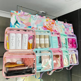 Hanging Toiletry Bags hanging side by side in shower on glass with their hooks by Mindful Marlo in designs Romy, Fleur Ivy, Haven and Willow