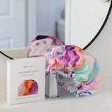 A colourful shower cap to keep your hair dry with design by artist Jade Fisher.