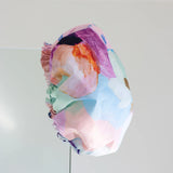 A colourful shower cap to keep your hair dry with design by artist Jade Fisher.