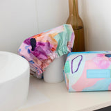 A colourful shower cap to keep your hair dry with design by artist Jade Fisher.