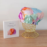 A colourful shower cap to keep your hair dry with design by artist Jade Fisher.
