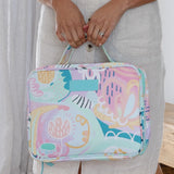 Hanging Toiletry Bag from Mindful Marlo in Haven design, closed and holding with handles