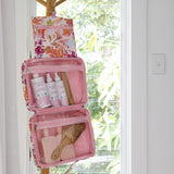 Hanging Toiletry Bag by Mindful Marlo in Ivy design, hanging with hook and holding products in spacious compartments