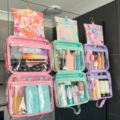 Hanging Toiletry Bags hanging side by side in shower on glass with their hooks by Mindful Marlo in designs Ivy, Haven and Willow