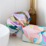 A colourful shower cap to keep your hair dry with design by artist Jade Fisher.