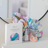 A colourful shower cap to keep your hair dry with design by artist Jade Fisher.