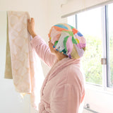 A colourful shower cap to keep your hair dry with design by artist Jade Fisher.