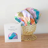 A colourful shower cap to keep your hair dry with design by artist Jade Fisher.
