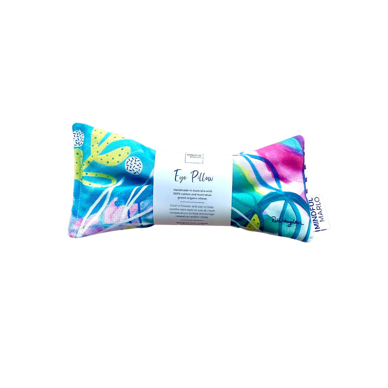 Aria Eye Pillow with belly band wrapped around it. This Eye Pillow is predominately greens with a little pink.  